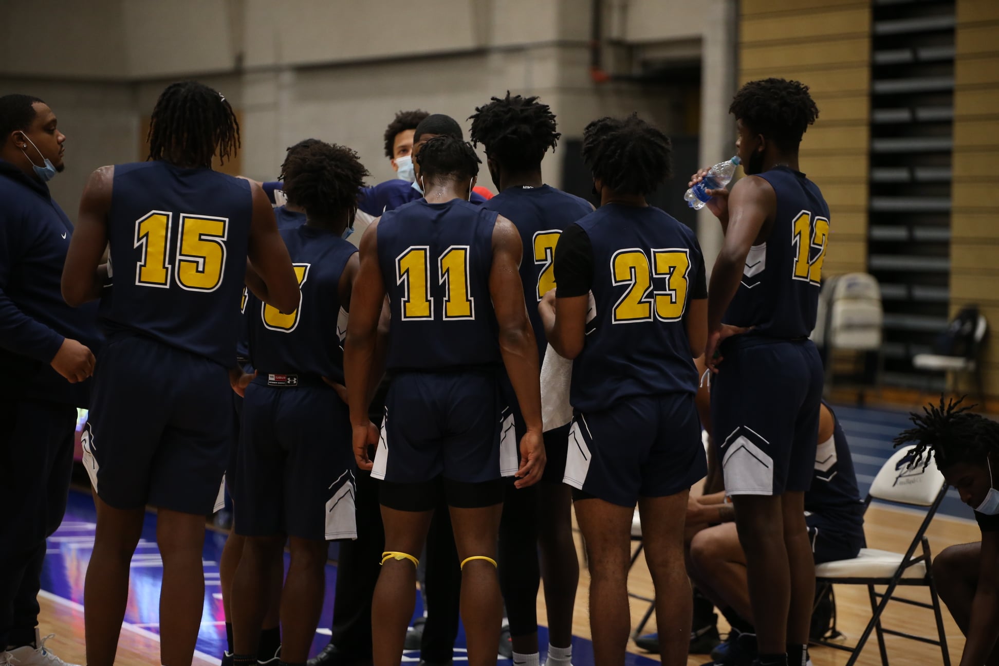 SC4 Men's basketball team in a huddle