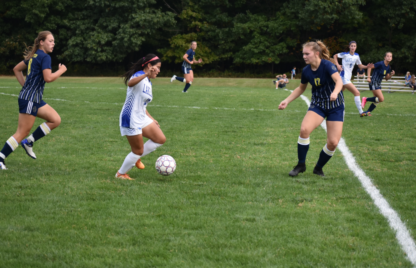 An SC4 women's soccer player playing defense against a Lakeland soccer player 