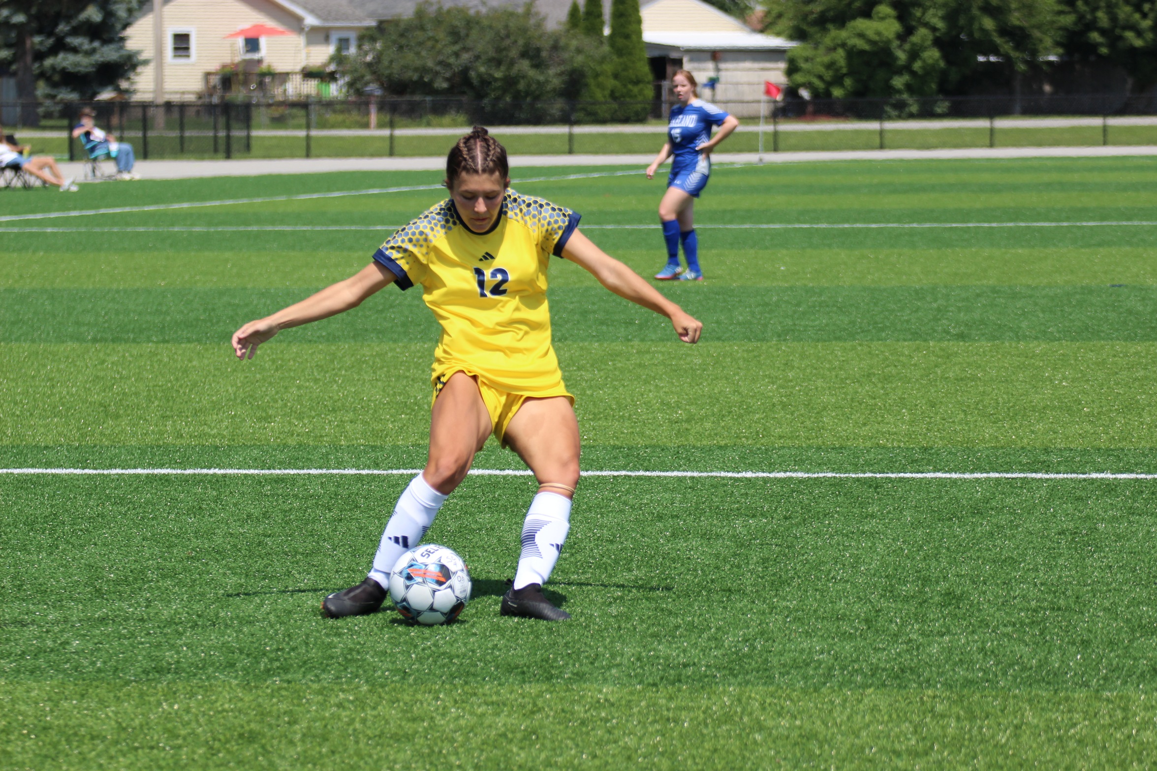 #12 Jessica Peters kicking a soccer ball
